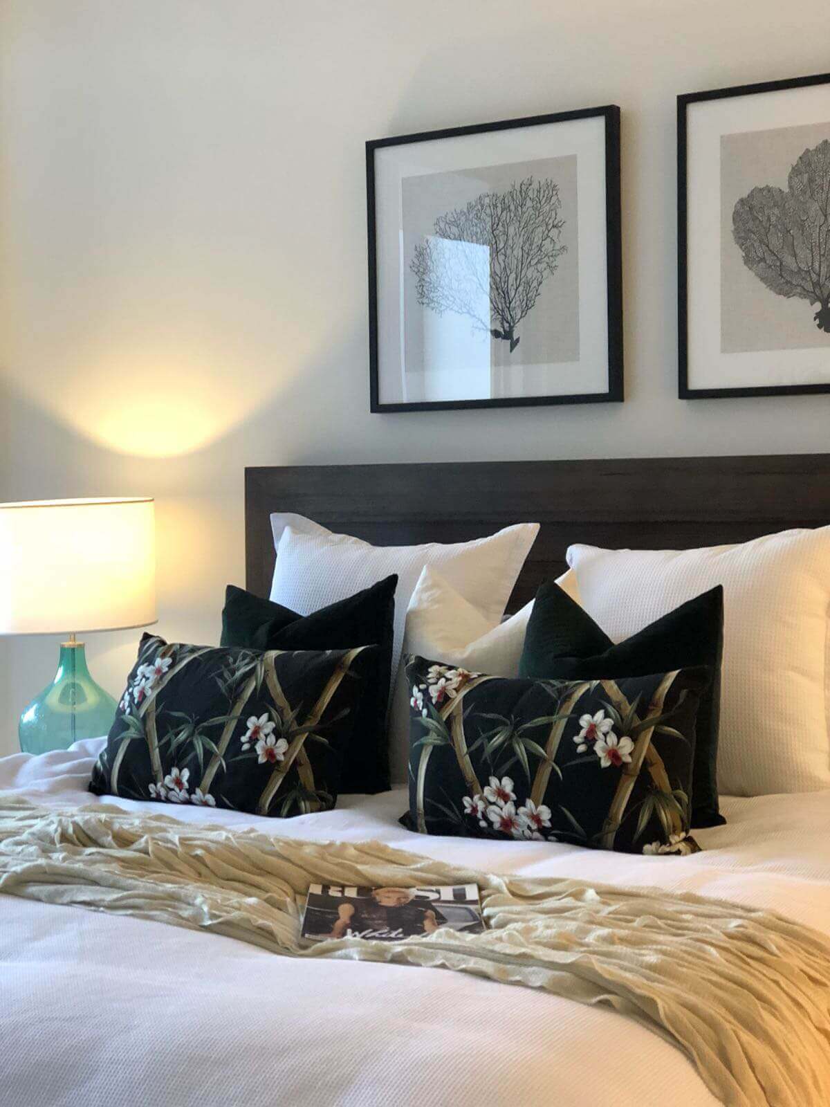 arranging cushions on bed